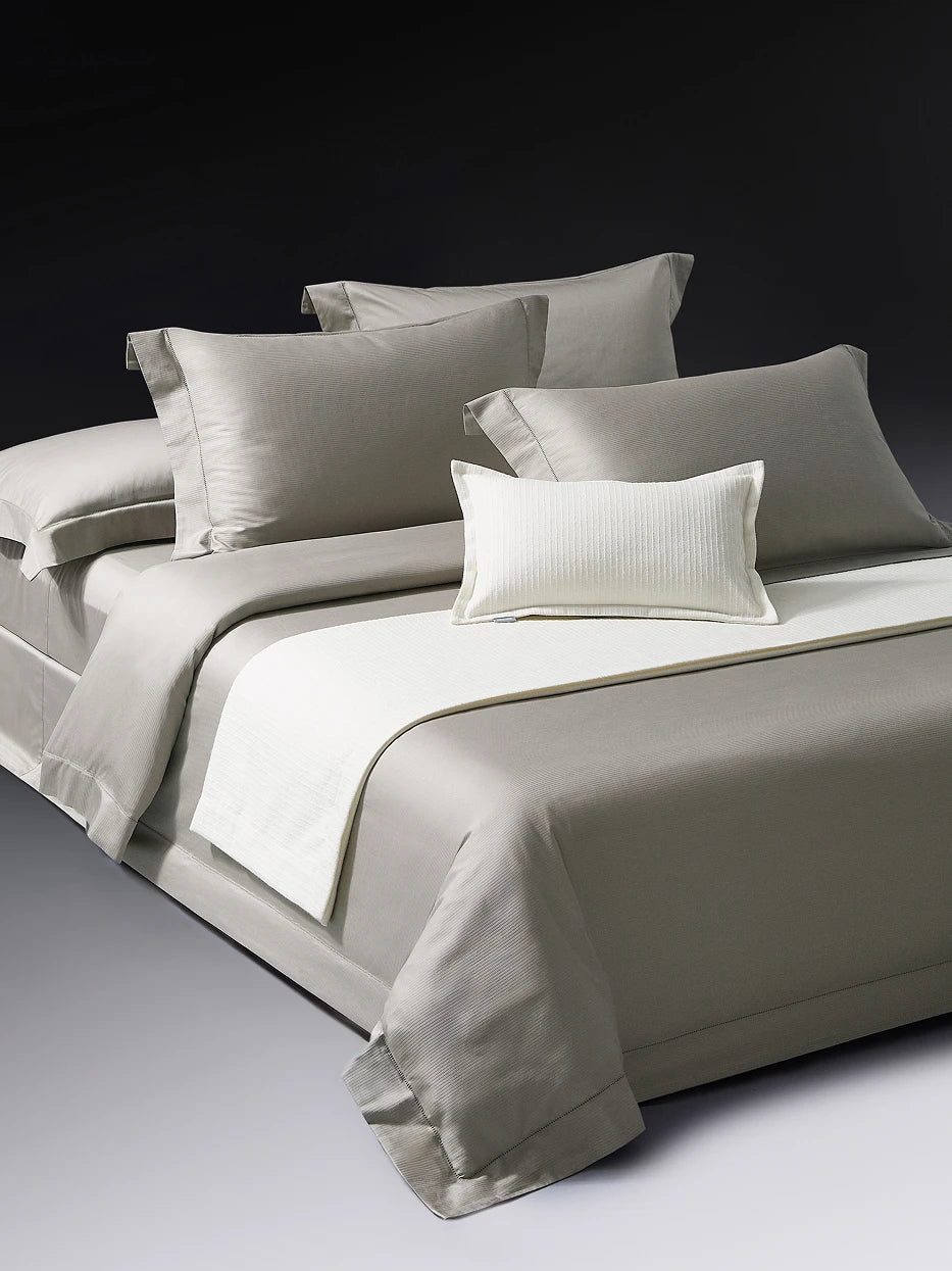 Close-up furnishing shot of full YALIAN bedding set showing vertical mini jacquard fabric & delicate cutwork edge