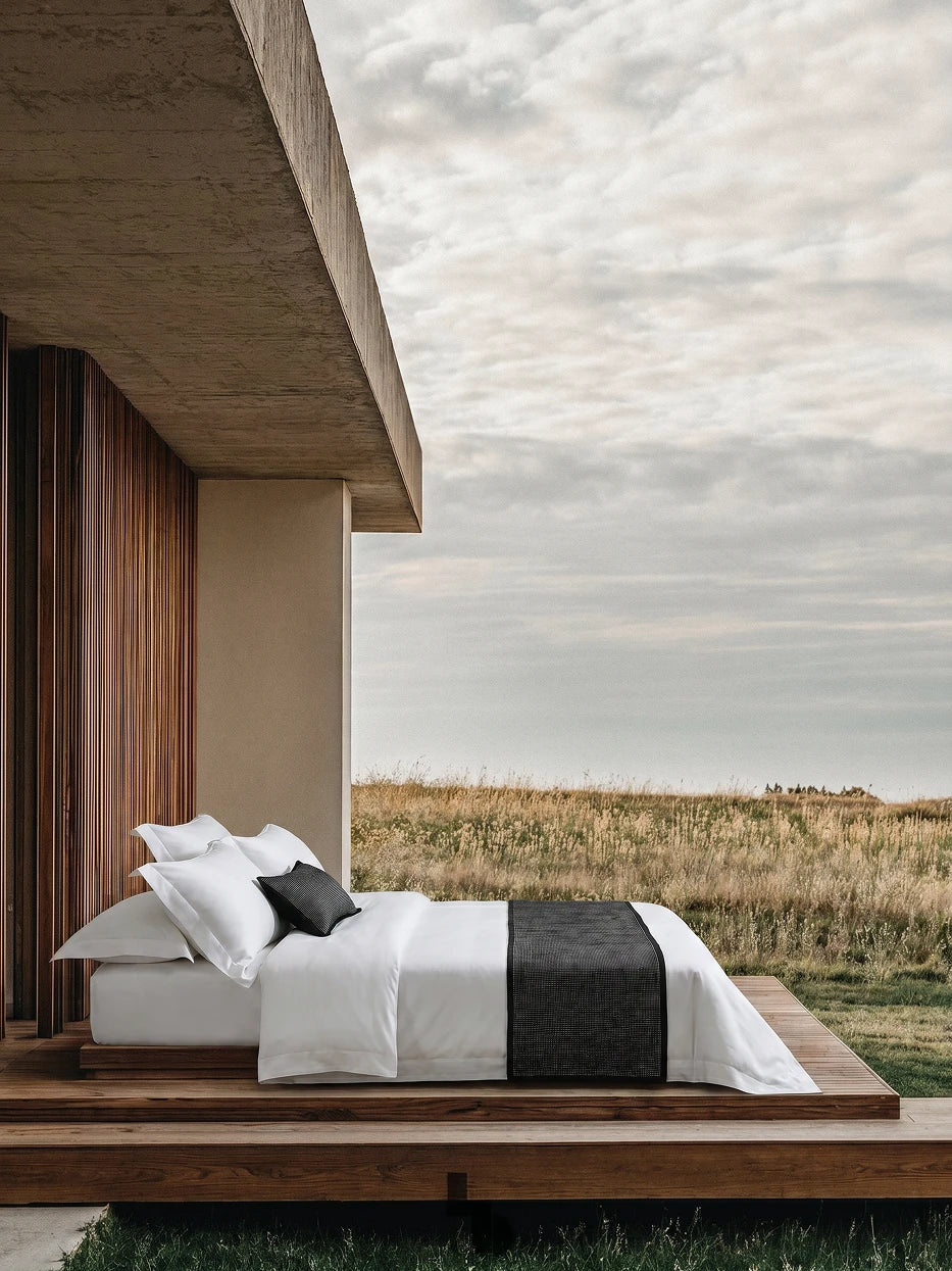 Wabi wilderness bedroom furnishing full view shot of YALIAN white L-size bedding set laid on solid wood bed platform beside floor-to-ceiling meadow window