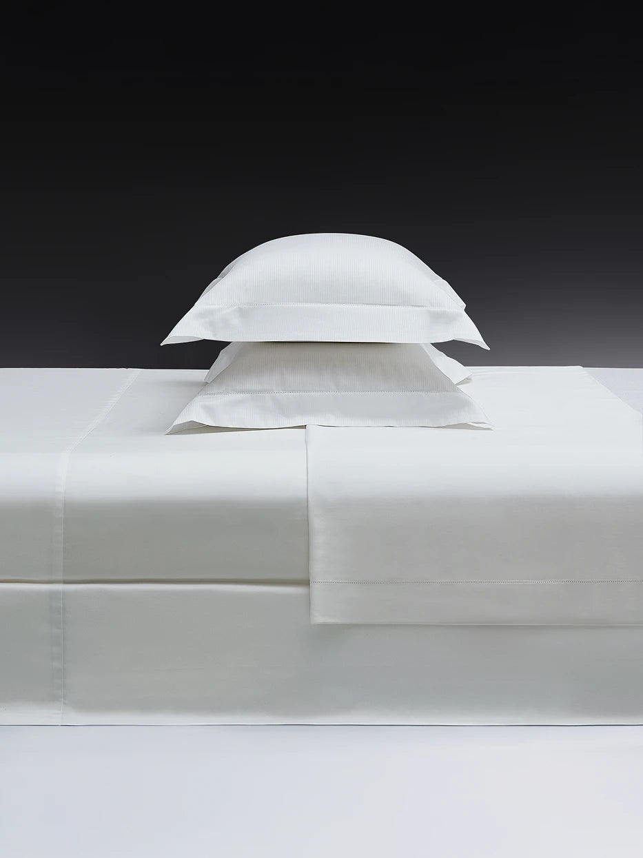 Close-up furnishing shot of full YALIAN white M size bedding pillow set showing vertical mini jacquard fabric & delicate cutwork edge