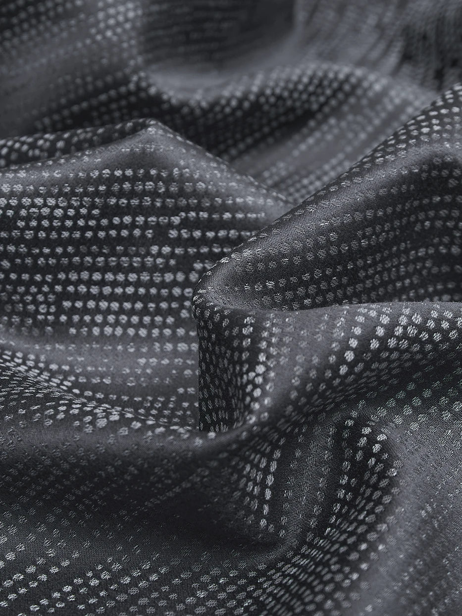 Soft natural light close-up shot of YAOLAN dark gray cotton fabric, showing even delicate dot yarn-dyed jacquard, tight high-density 600TC weaving