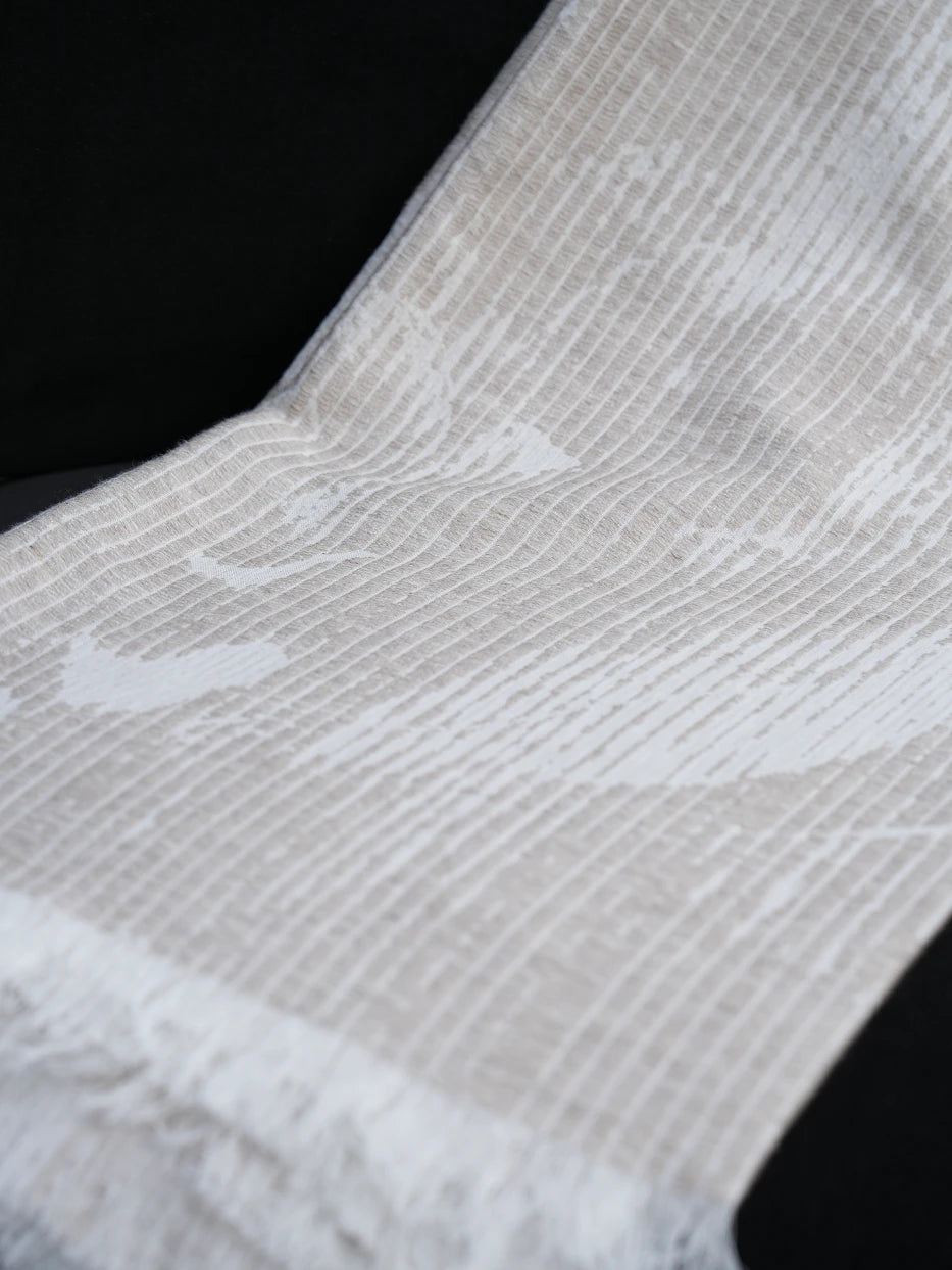 Extreme close-up texture shot of YUNQI linen wool blend throw blanket, showing dense vertical ribbed texture, faint misty floral jacquard pattern and loose handmade tassel fringe detail, visible breathable linen weave and soft wool mixed touch, neatly cut natural fringed edges, displays premium multi-fabric craft and delicate jacquard tactile texture for home textile product display